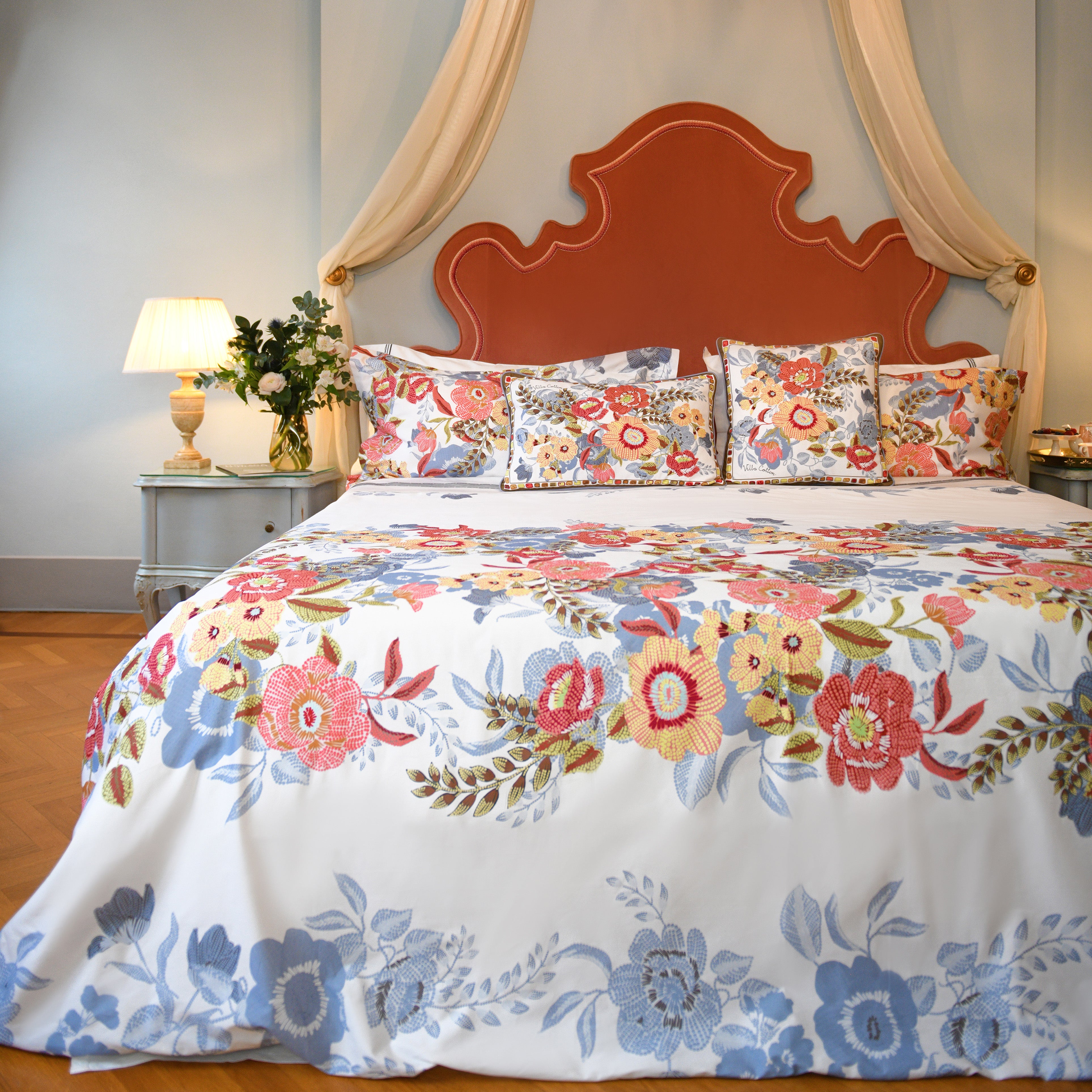 White printed duvet cover set with colorful village-inspired floral pattern on luxury bed in classic interior
