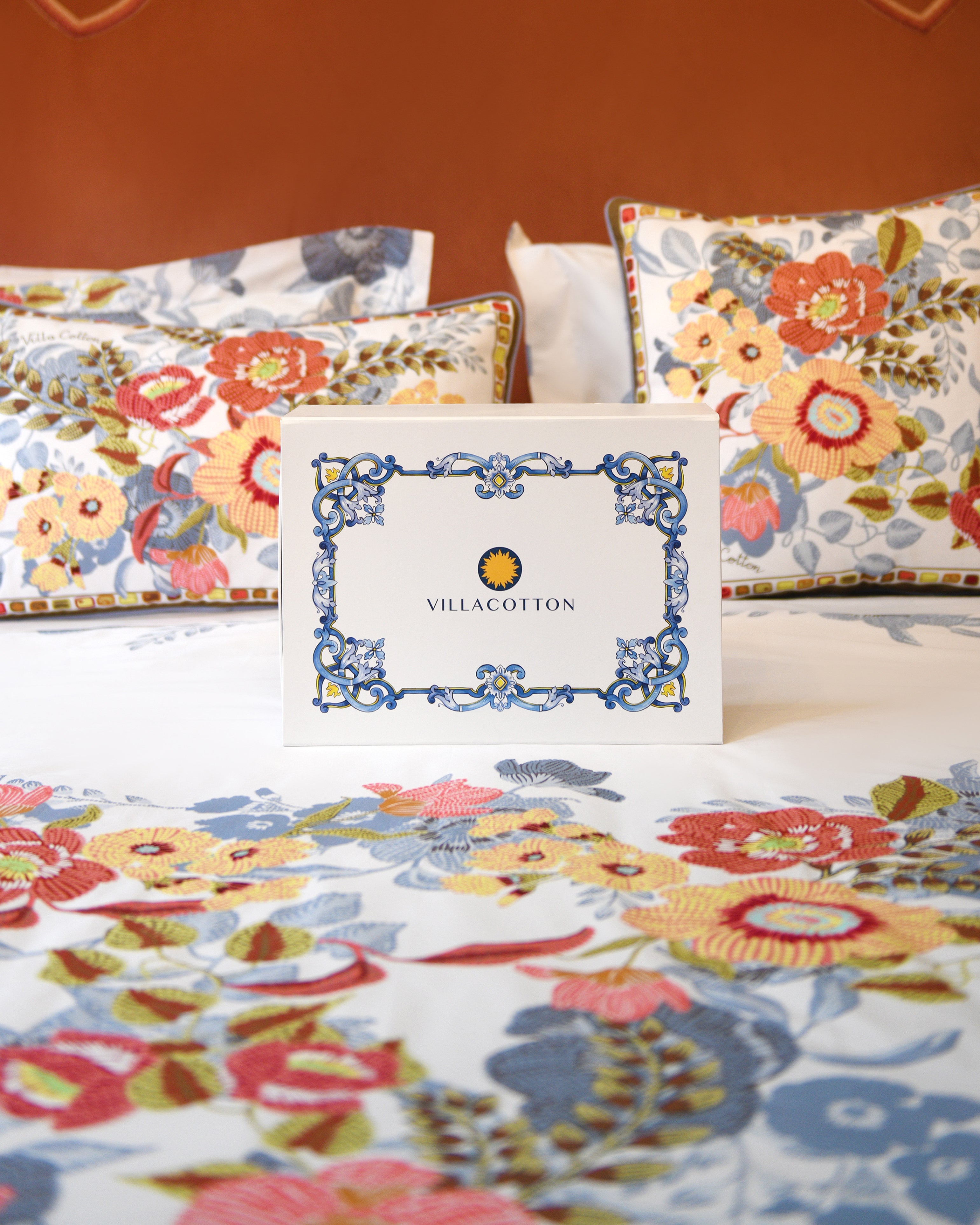 Gift box on Villaggio duvet cover set with floral print shams and Villa Cotton branded packaging