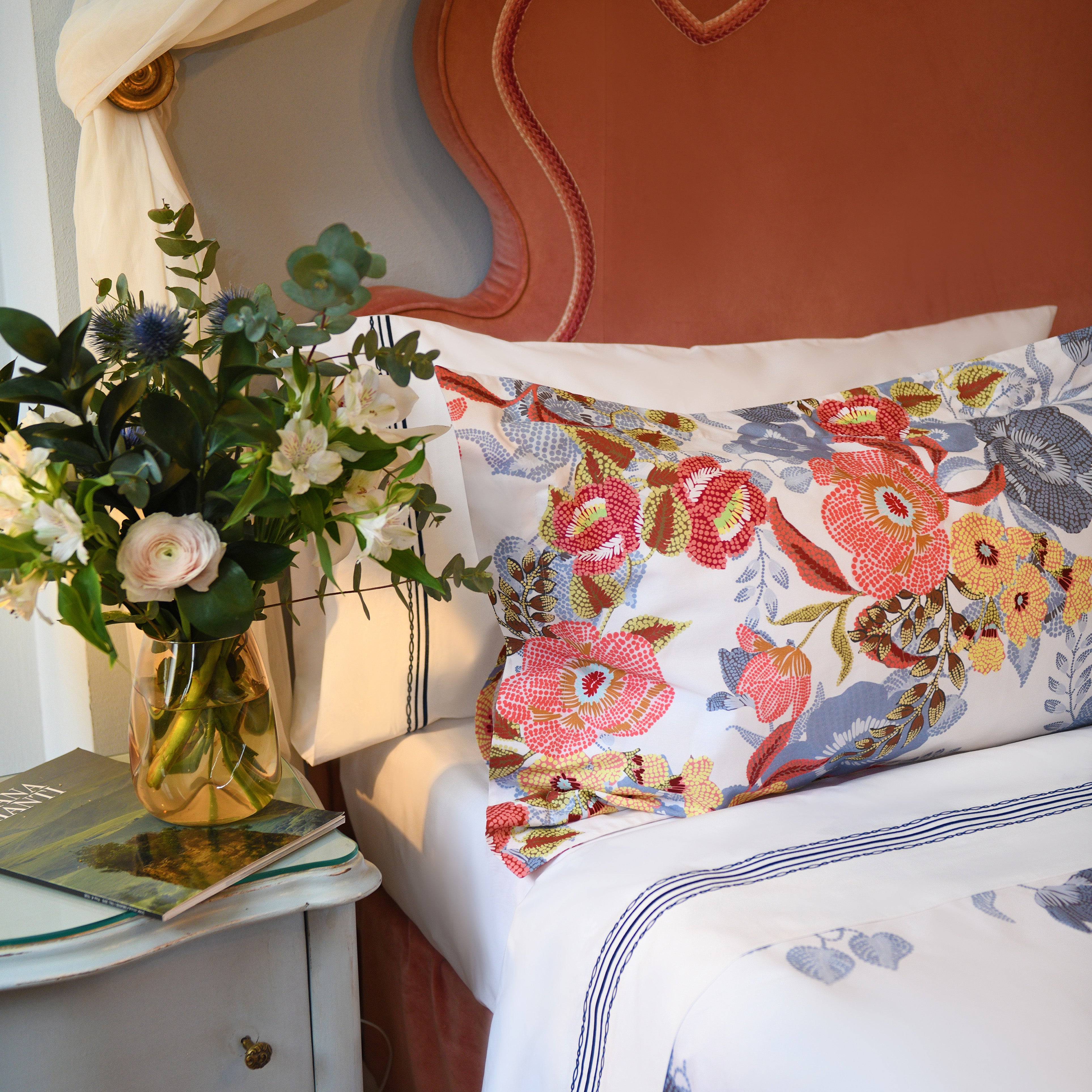 Close-up of pillow sham from Villaggio set with multicolored floral print on soft white cotton