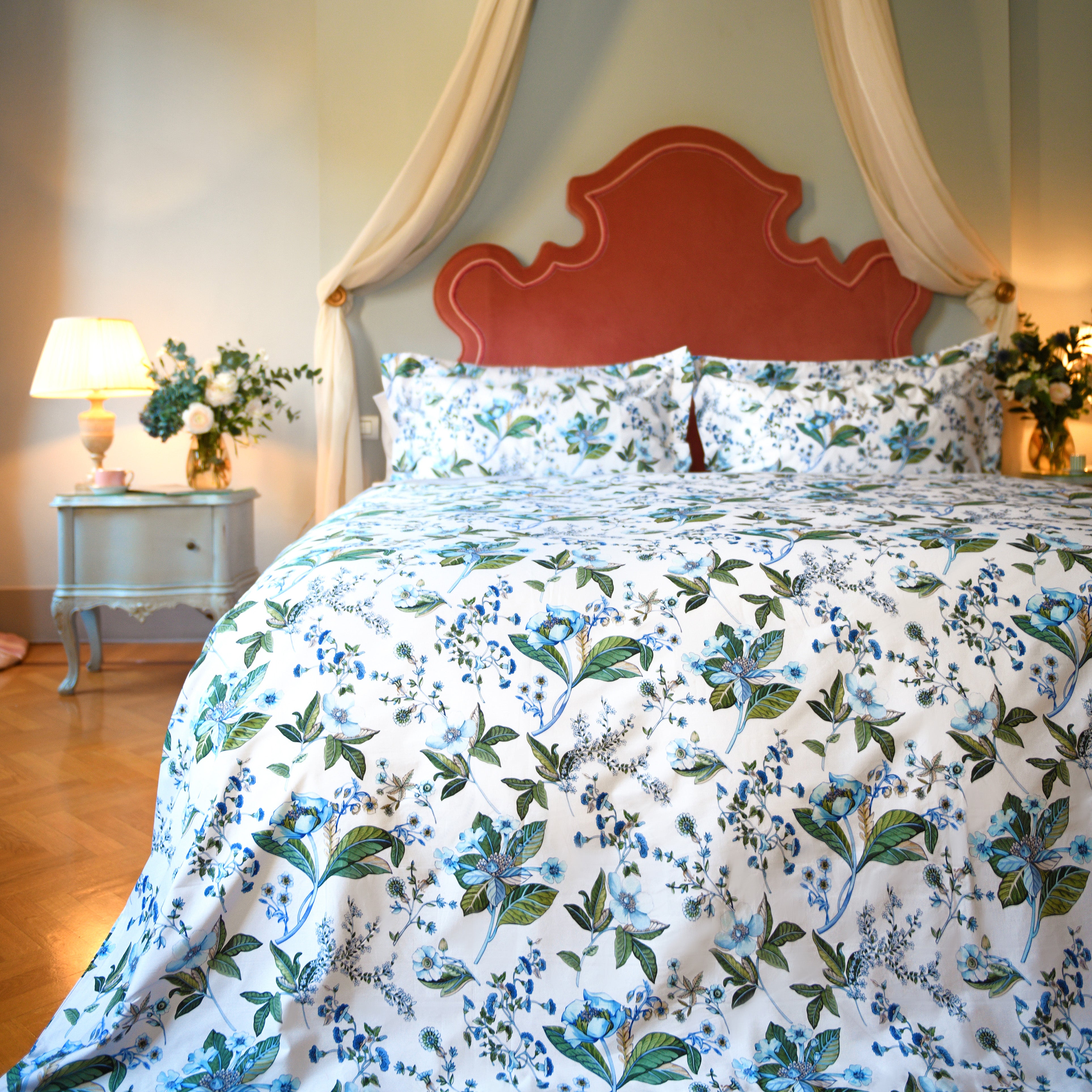 Printed cotton duvet cover set with vibrant Fantasia floral design in elegant bedroom with coral headboard