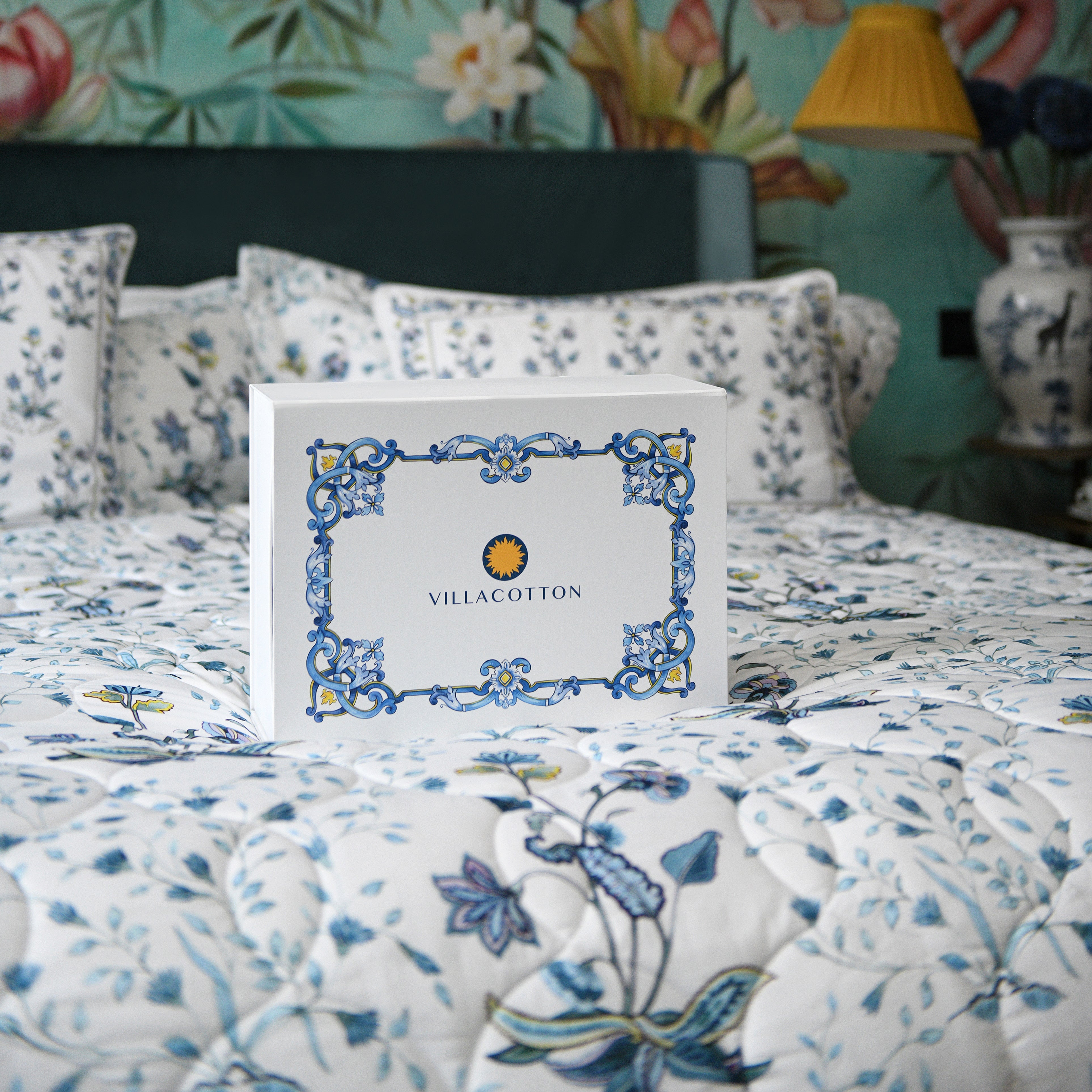Villa Cotton gift box placed on floral printed Fiori duvet cover in elegant bedroom setting