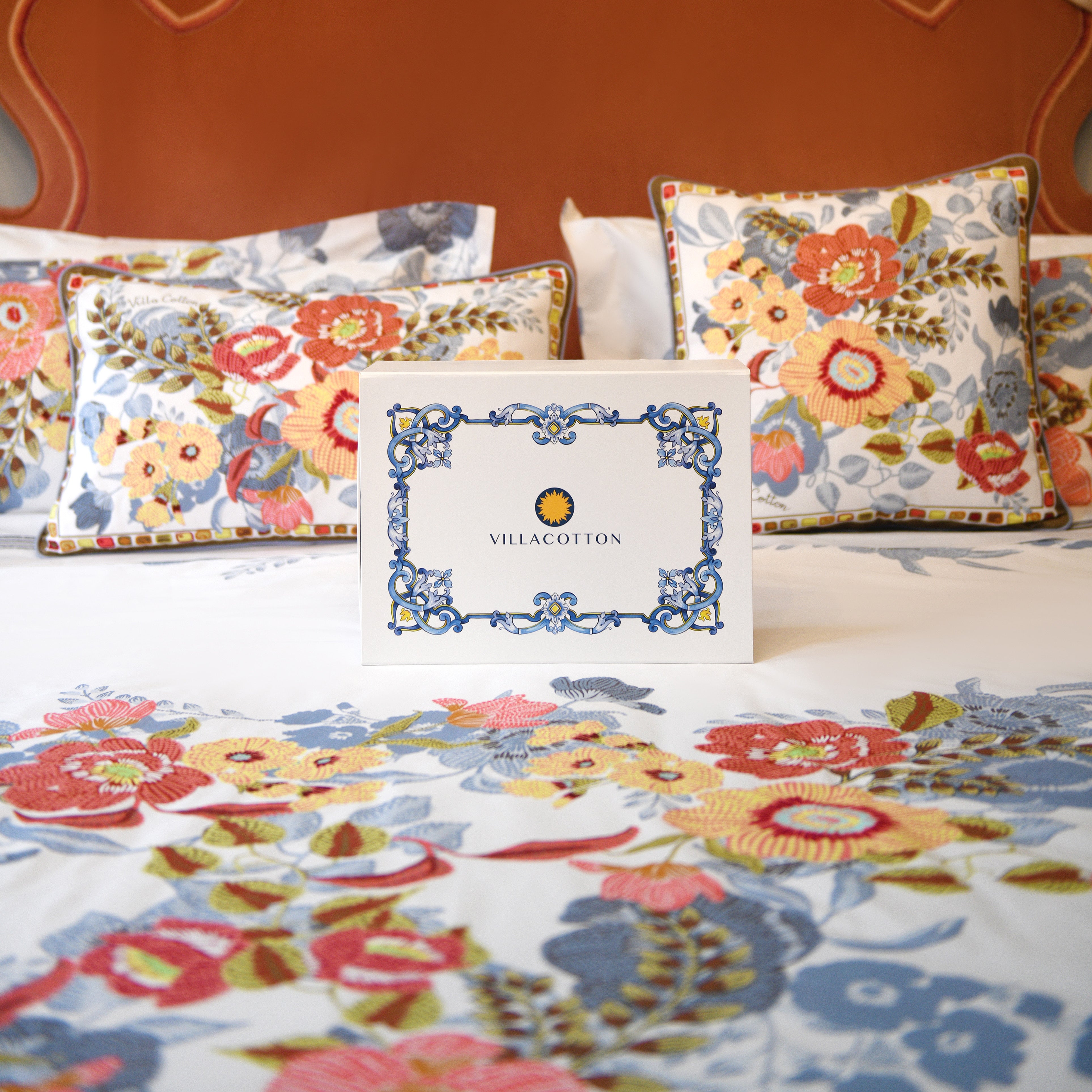 Gift box on Villaggio duvet cover set with floral print shams and Villa Cotton branded packaging